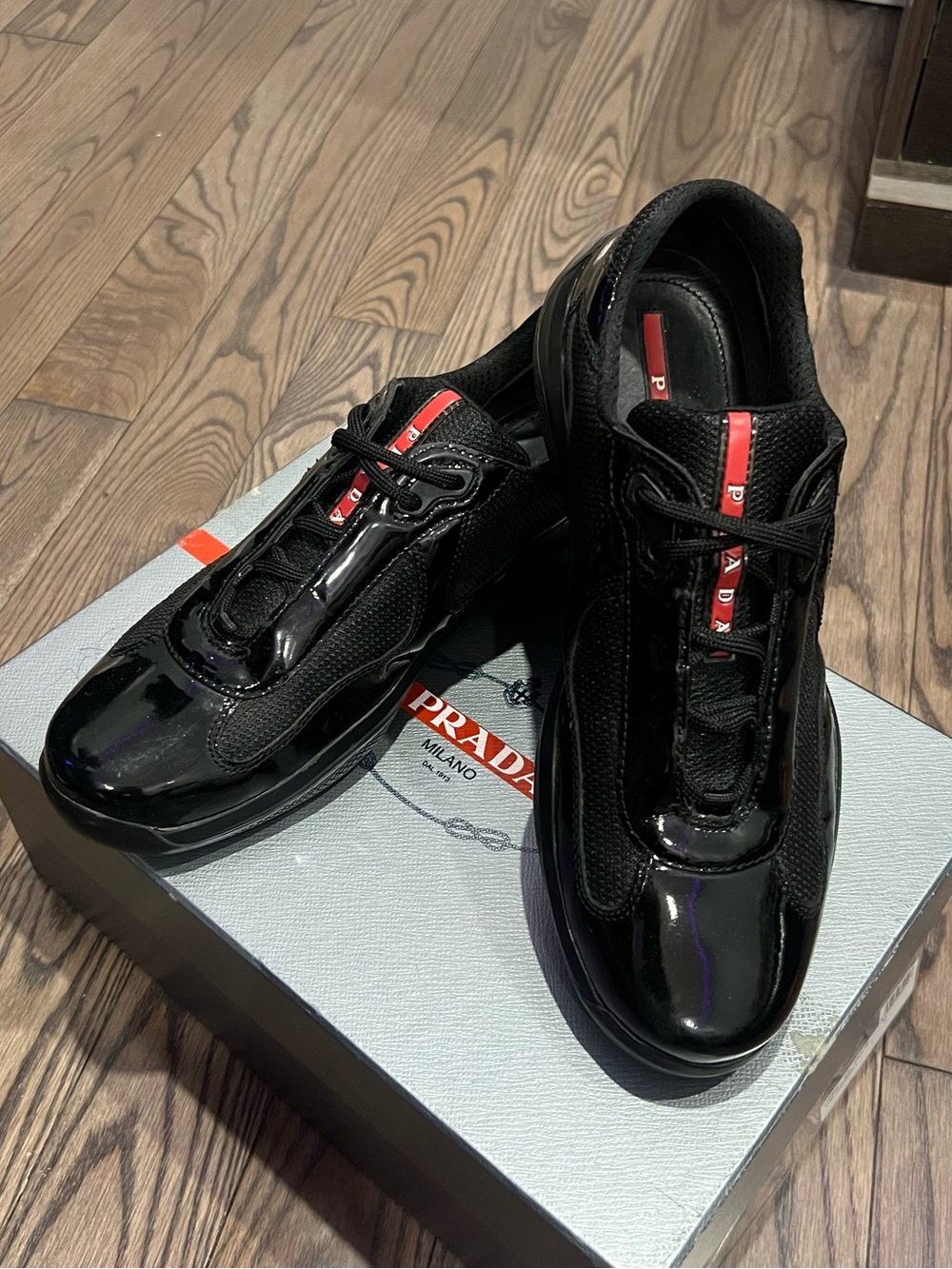 Prada Black Low-Top Sneakers with Red Logo Stripe
